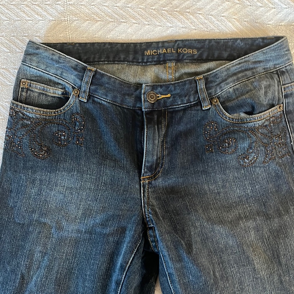 Michael Kors dark washed denim boot cut jeans with embellishments. Size 6.
